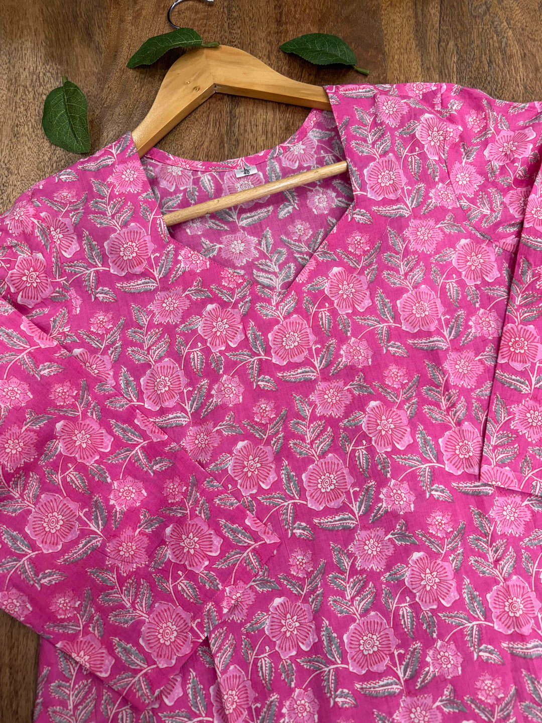 Close-up shot of the pink floral print cotton kurta, highlighting the elegant sweetheart neckline and detailed screen print design.
