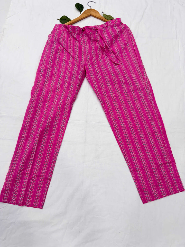 Detailed view of the matching pink printed cotton straight-leg pants, showing the fabric texture and print pattern.