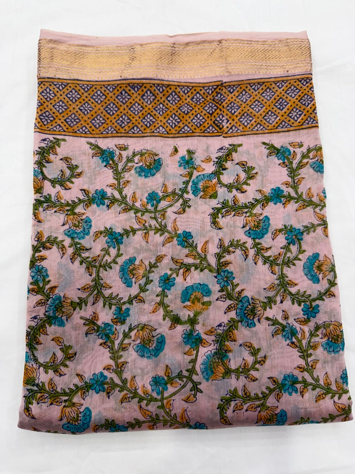 Close-up of the unstitched pink Maheshwari silk kurta fabric, featuring traditional Sanganeri hand block printed floral motifs in shades of blue and green.