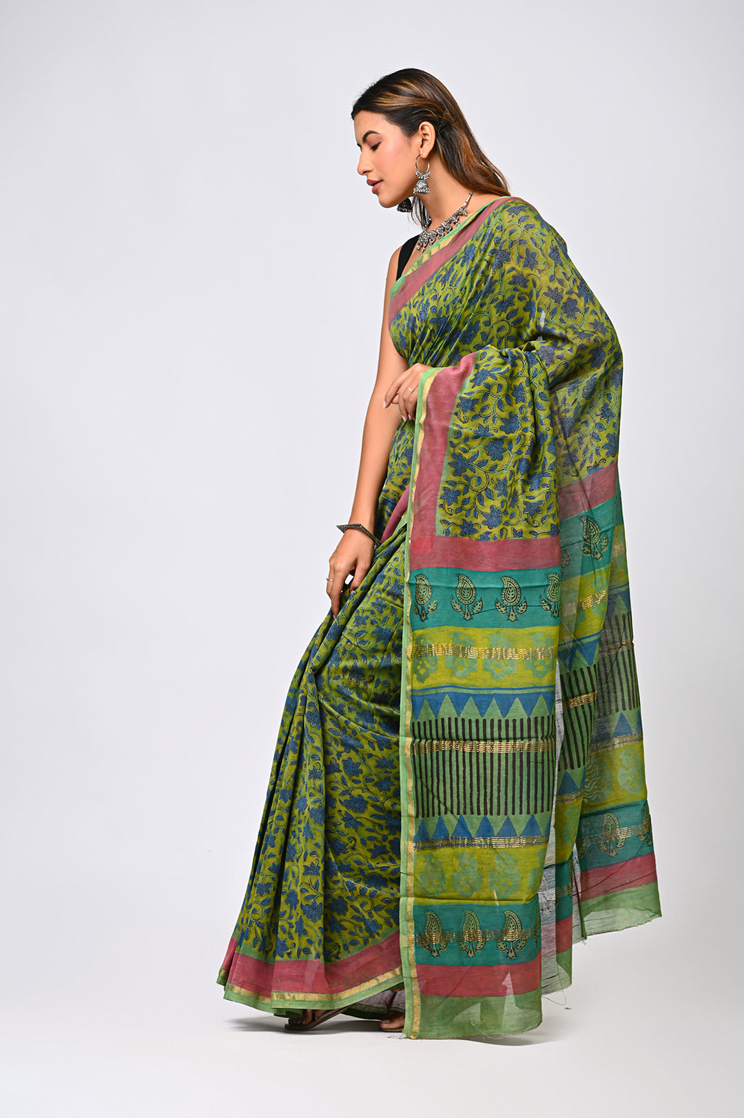 An authentic plant-based herbal dyed green Chanderi silk saree by Bagru Hastkala Printers, showcasing a lustrous texture, fluid drape, and traditional Rajasthani block prints.
