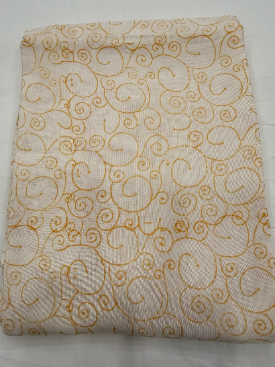 Premium quality cream-coloured Santoon silk unstitched bottom fabric for the Maheshwari silk suit set, smooth and neatly folded.