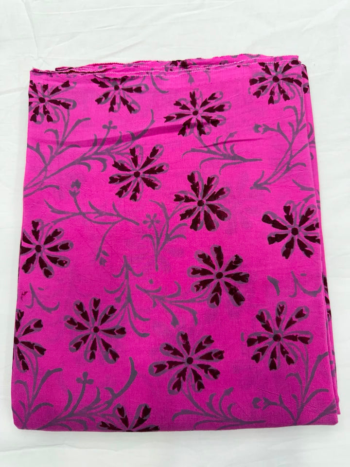 Premium quality unstitched Santoon silk bottom fabric in bright gulabi pink with contrasting black block prints, neatly rolled for the Maheshwari silk suit set.