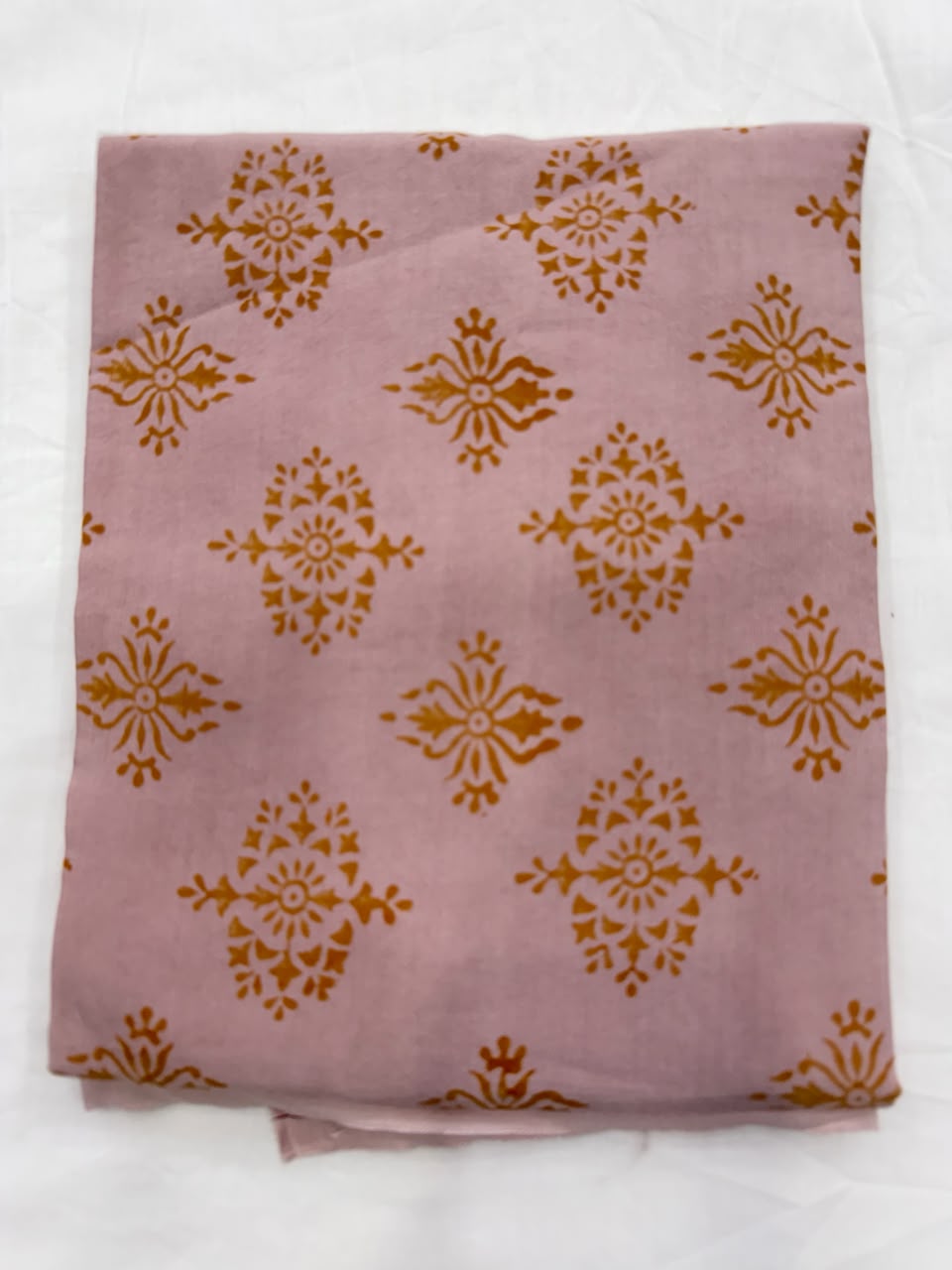 Premium quality soft pink unstitched Santoon silk bottom fabric, neatly rolled for the Sanganeri block print Maheshwari silk suit set.