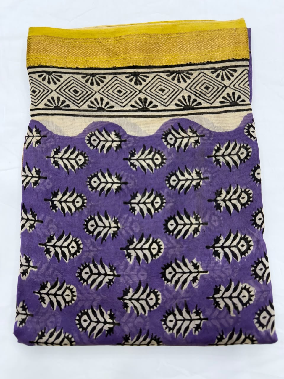 Close-up of the unstitched royal purple Maheshwari silk kurta fabric, highlighting the traditional, delicate all-over Bagru buti floral motifs hand-printed by master artisans.