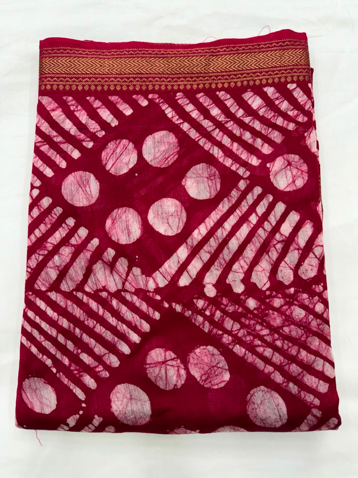 Close-up of the unstitched red Maheshwari silk kurta fabric, featuring traditional wax-resist batik hand block printed geometric patterns in crisp white.
