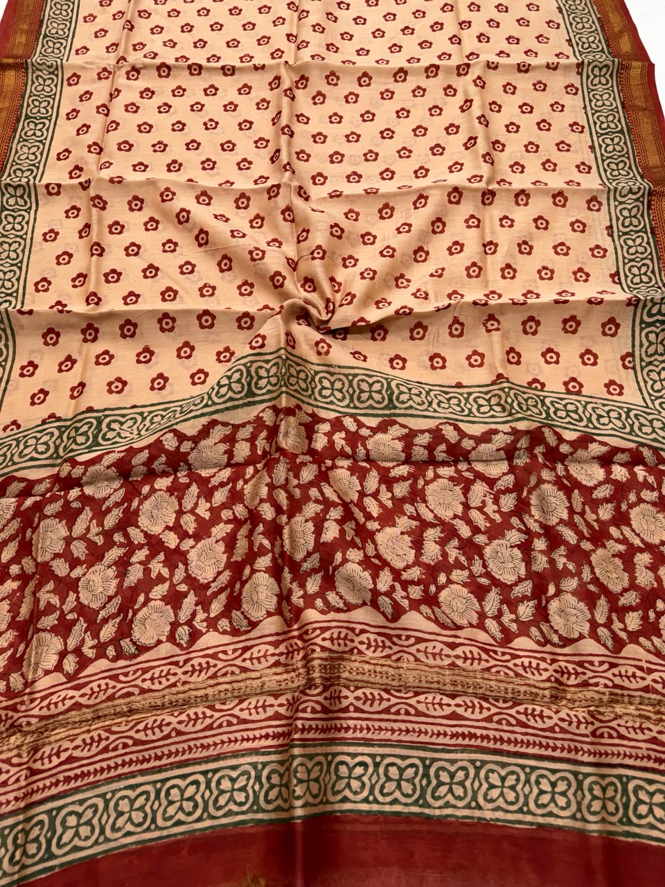 Detailed view of the cream and rust red handloom Maheshwari silk dupatta, highlighting the traditional Bagru block-printed buti patterns and a premium handloom woven golden Zari border.