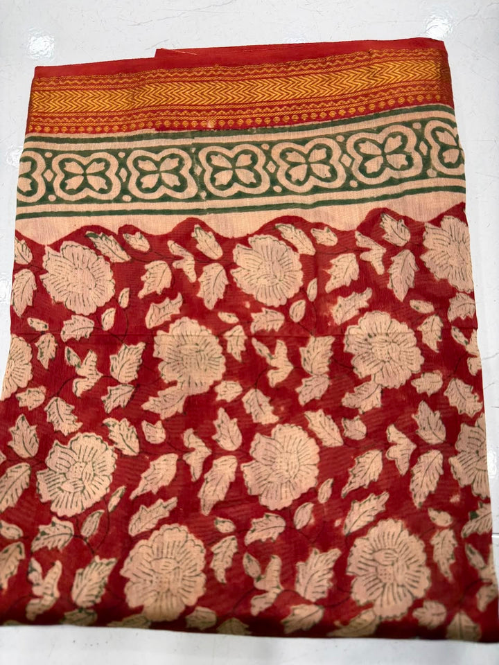 Close-up of the unstitched Maheshwari silk kurta fabric, featuring intricate, traditional all-over floral block print patterns in rich rust red and cream tones.