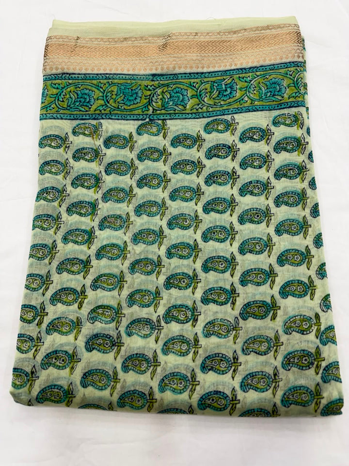 Close-up of the unstitched turquoise Maheshwari silk kurta fabric, featuring delicate, all-over traditional Sanganeri buti floral motifs hand-stamped by master block printers.