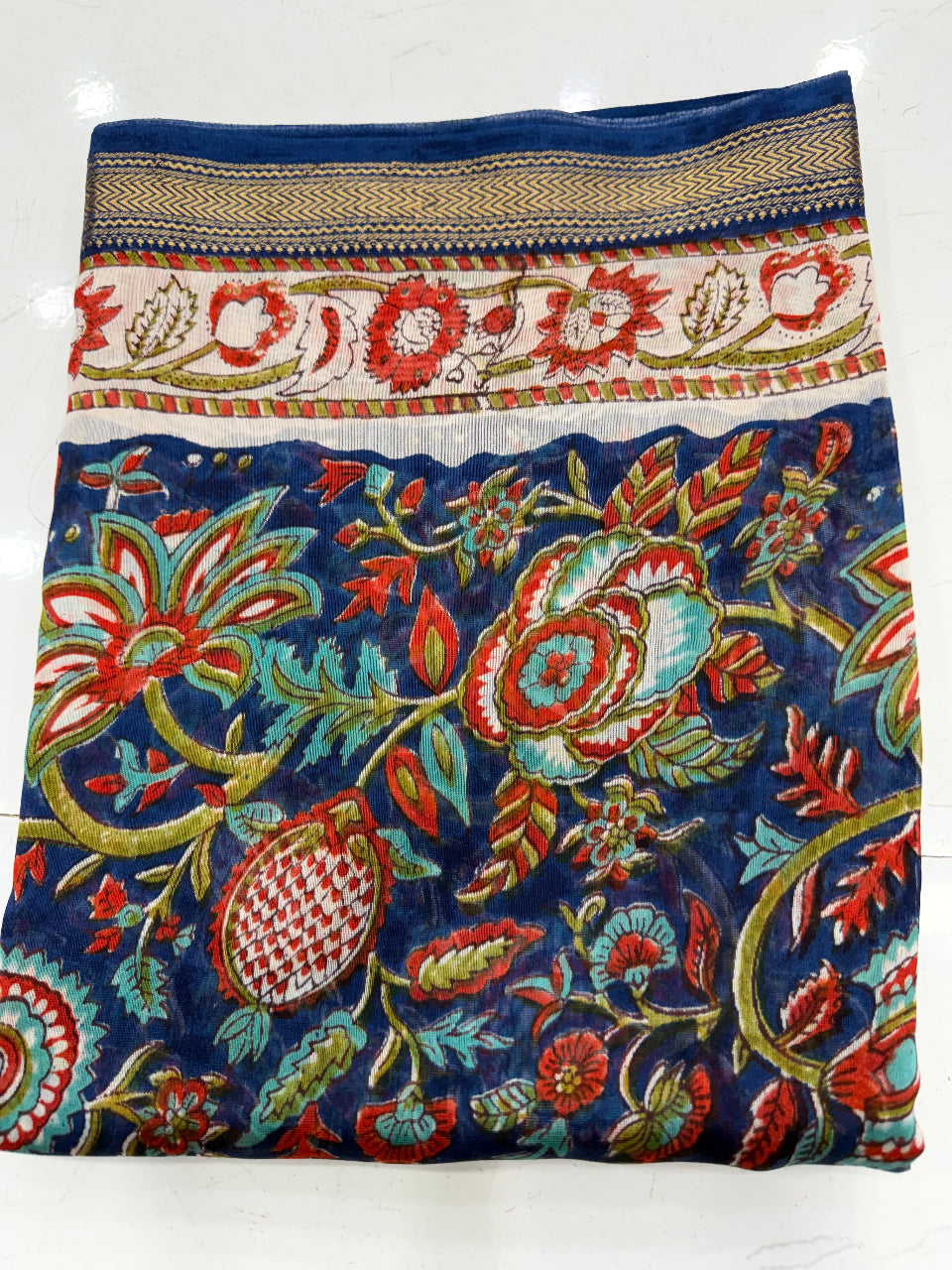 Close-up of the unstitched Maheshwari silk kurta fabric featuring traditional vibrant Sanganeri rapid floral block prints on a light base.
