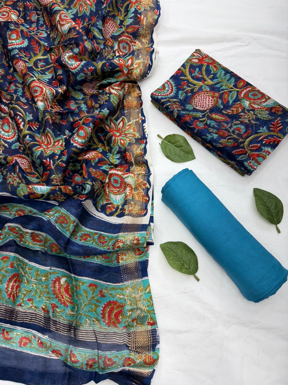 Close-up of the unstitched Maheshwari silk kurta fabric featuring traditional vibrant Sanganeri rapid floral block prints on a light base.