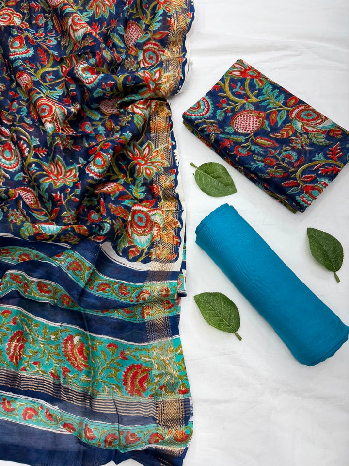 Close-up of the unstitched Maheshwari silk kurta fabric featuring traditional vibrant Sanganeri rapid floral block prints on a light base.