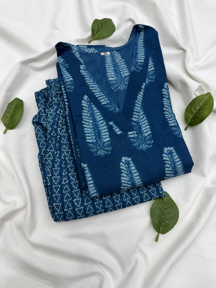 Top-down view of a matching deep indigo blue traditional motif printed kurta and bottom set neatly laid out.